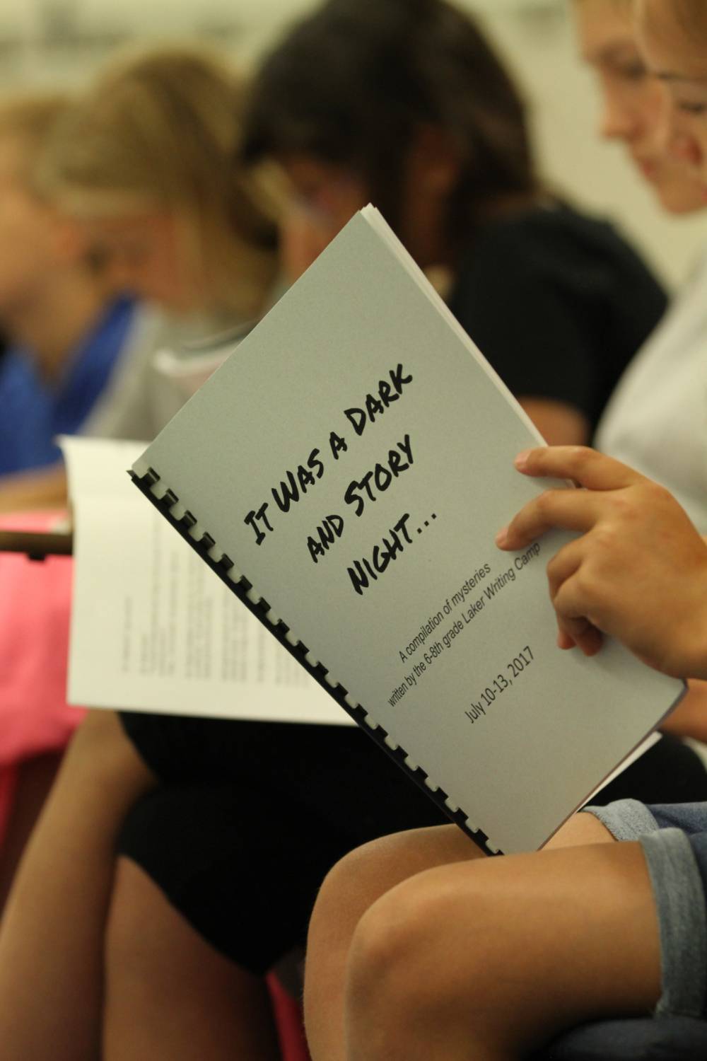 A student holds a packet during a Laker Writing Camp.